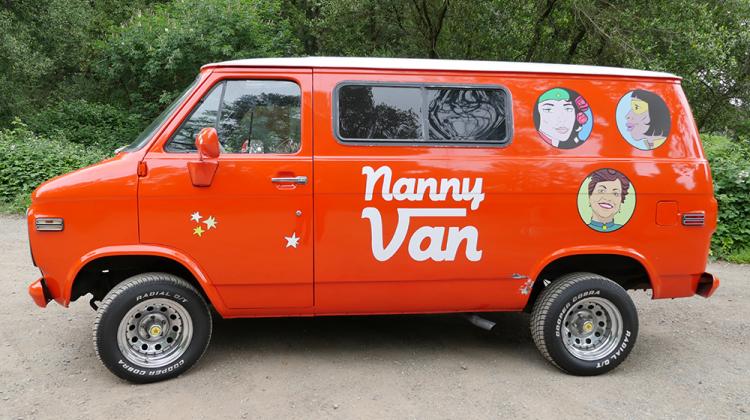 Bright orange superhero themed 1976 Chevy Van created by artistMarisa Morán Jahn